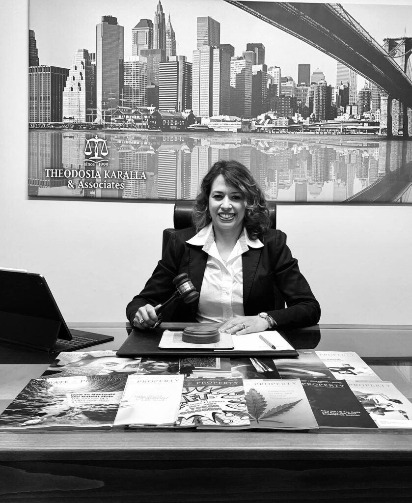 Real Estate attorney with a confident smile seated at a desk in a law office setting, surrounded by legal books, property law magazine books , a laptop, and documents concerning buying a house, with a backdrop of a city skyline poster.